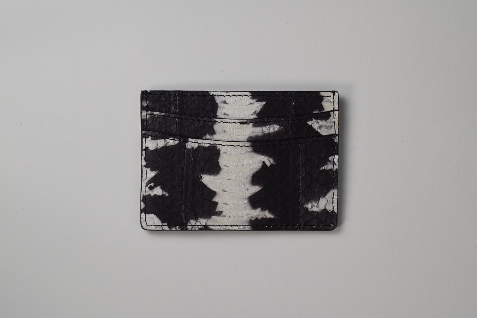 a black and white card holder on a white surface